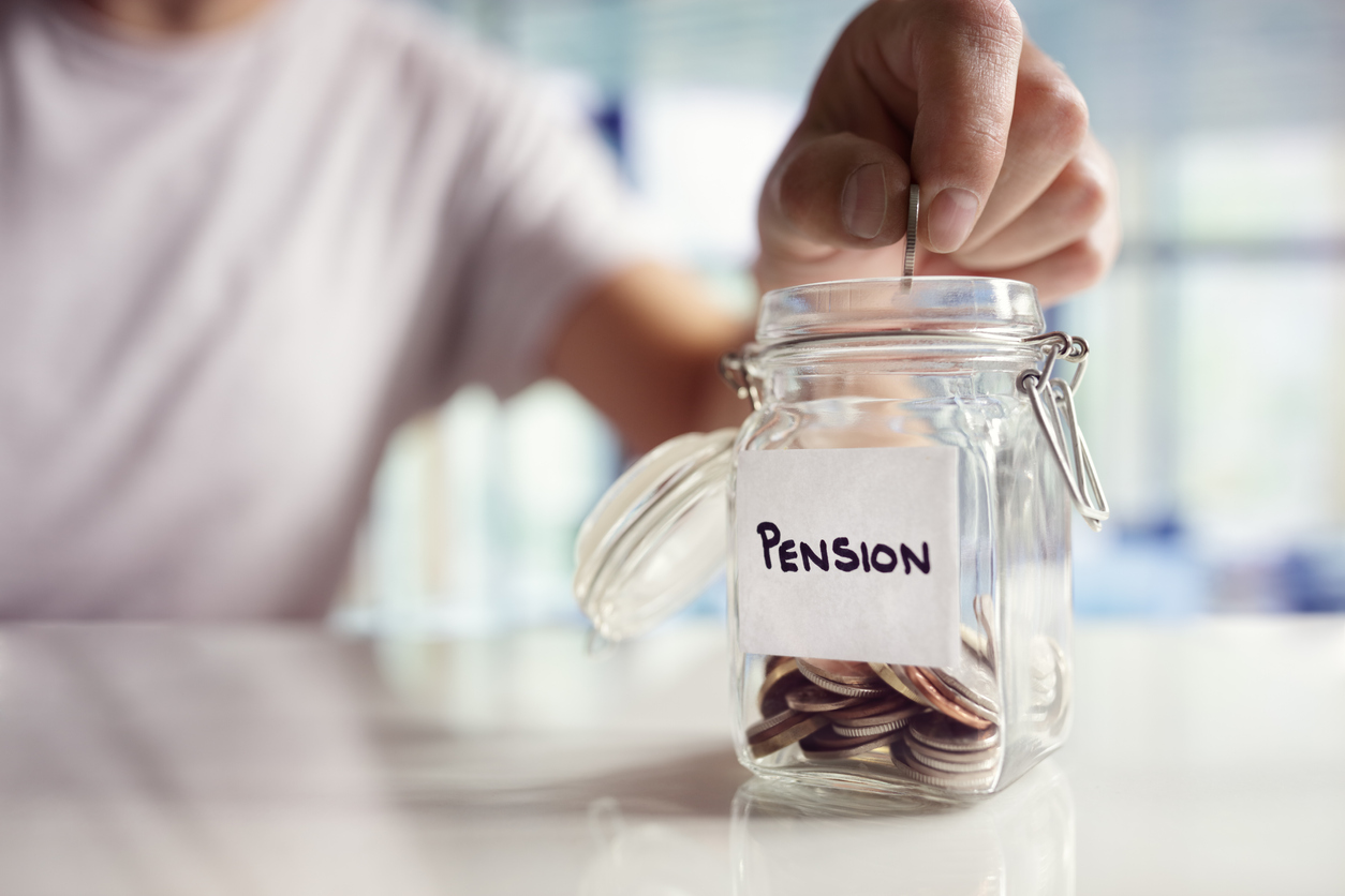 Person putting money in jar labelled Pension