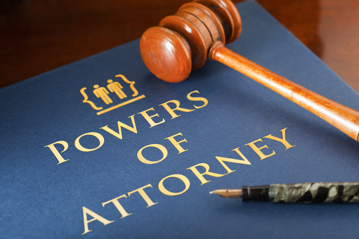 Gavel laying across book entitled Powers of Attorney