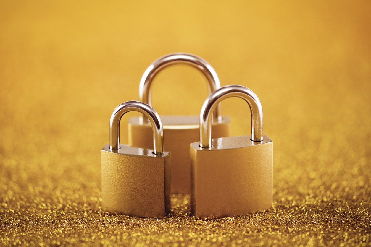 Three padlocks against a gold background