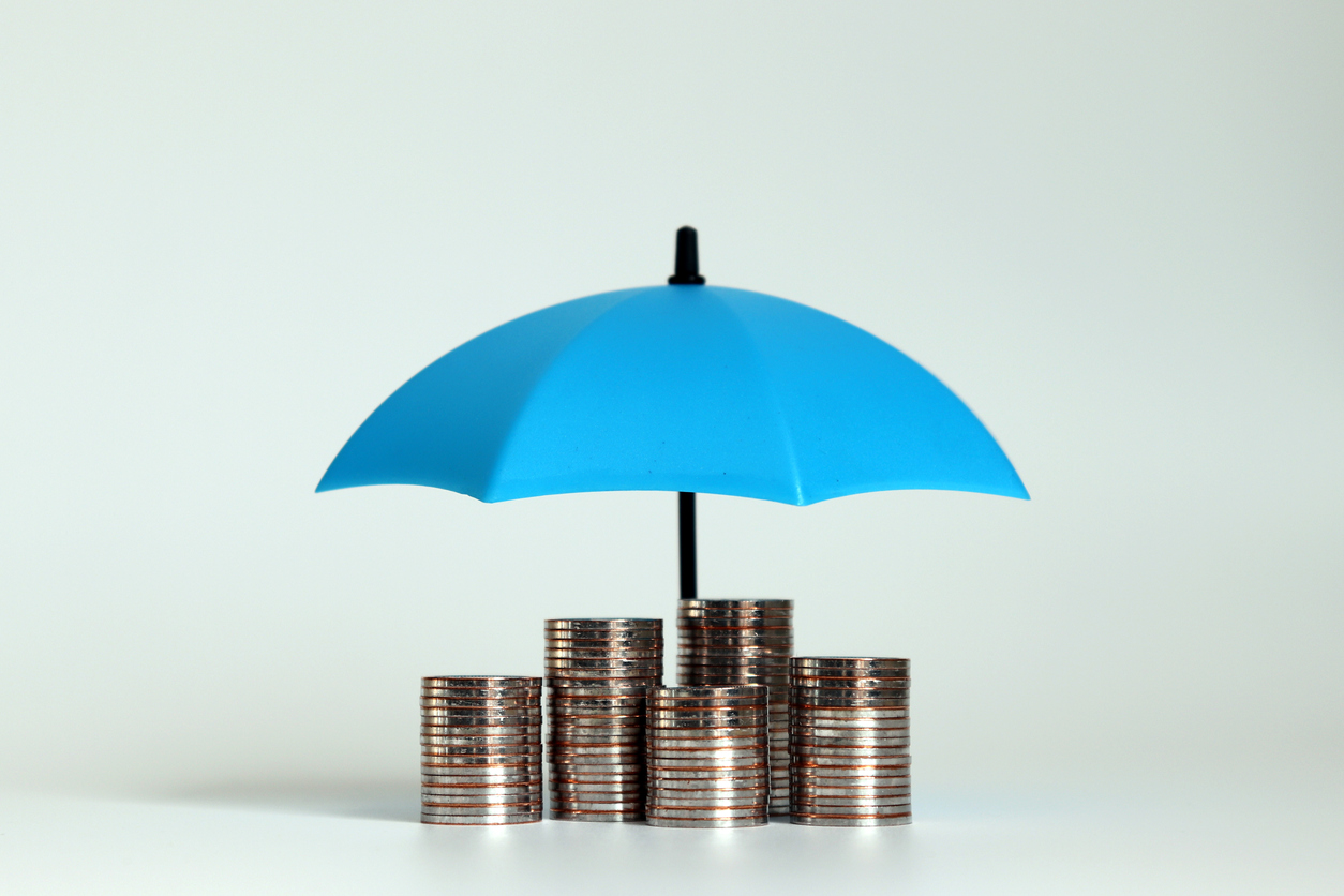 Pile of coins under a blue umbrella