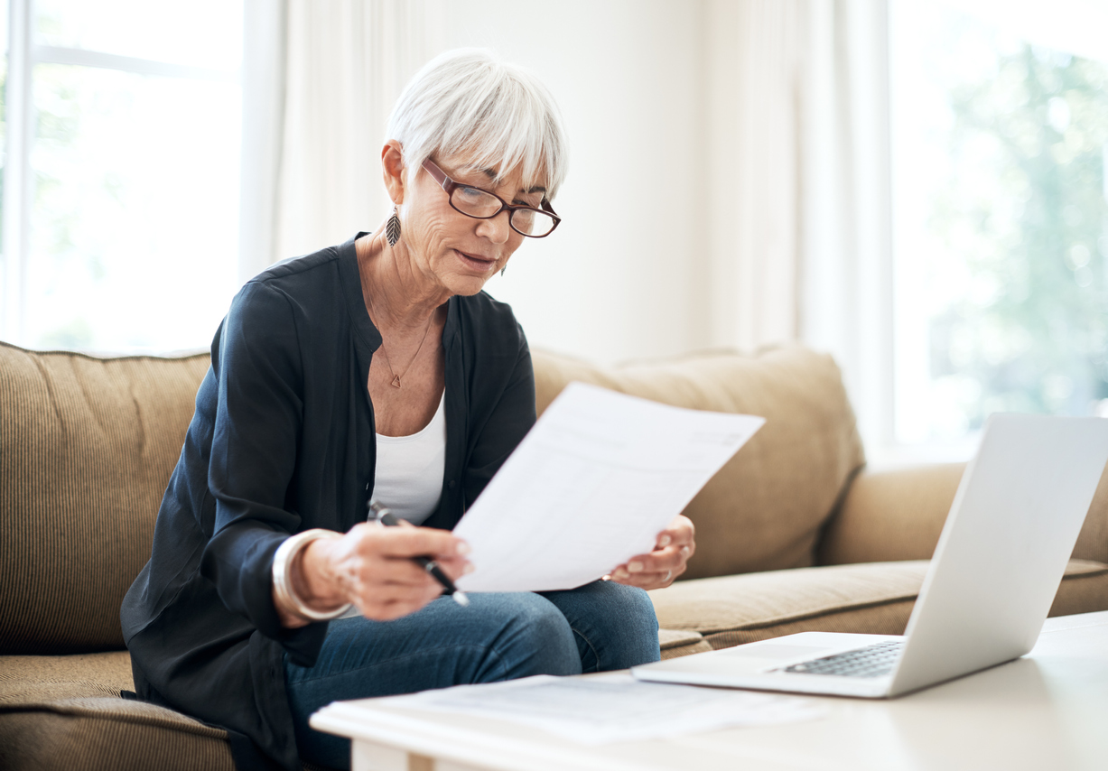 Mature woman looking over her financial papers