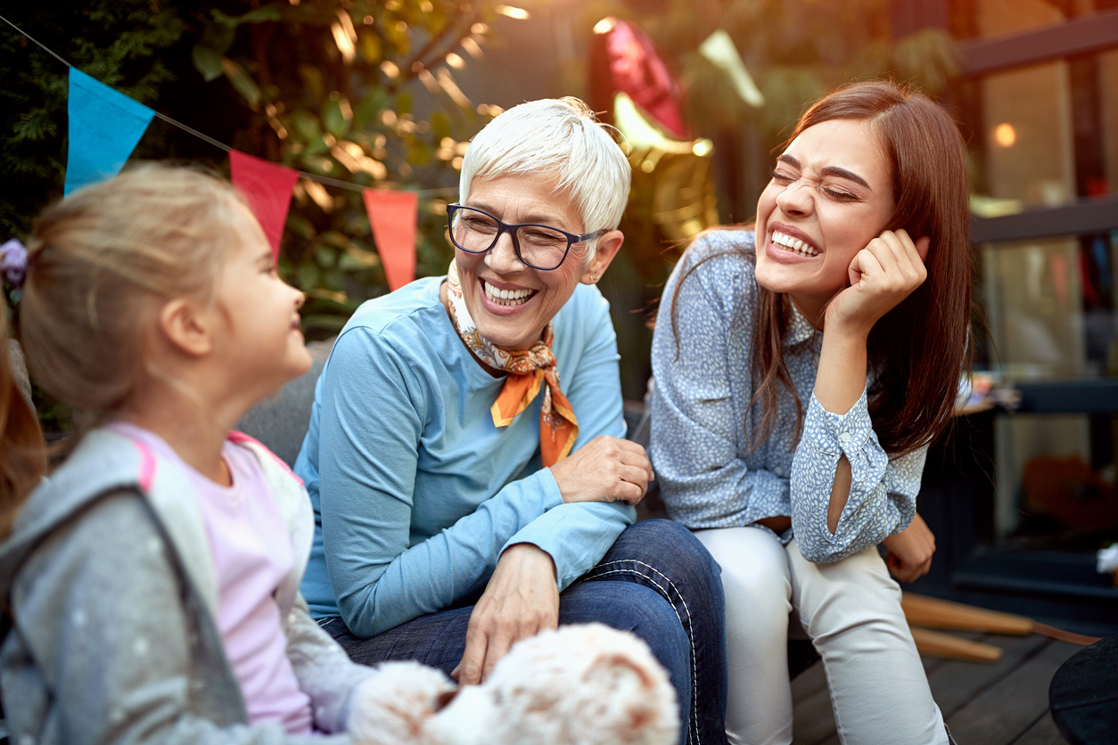 Grandmother, mother, and grandchild sitting chatting - Intergenerational wealth planning explained