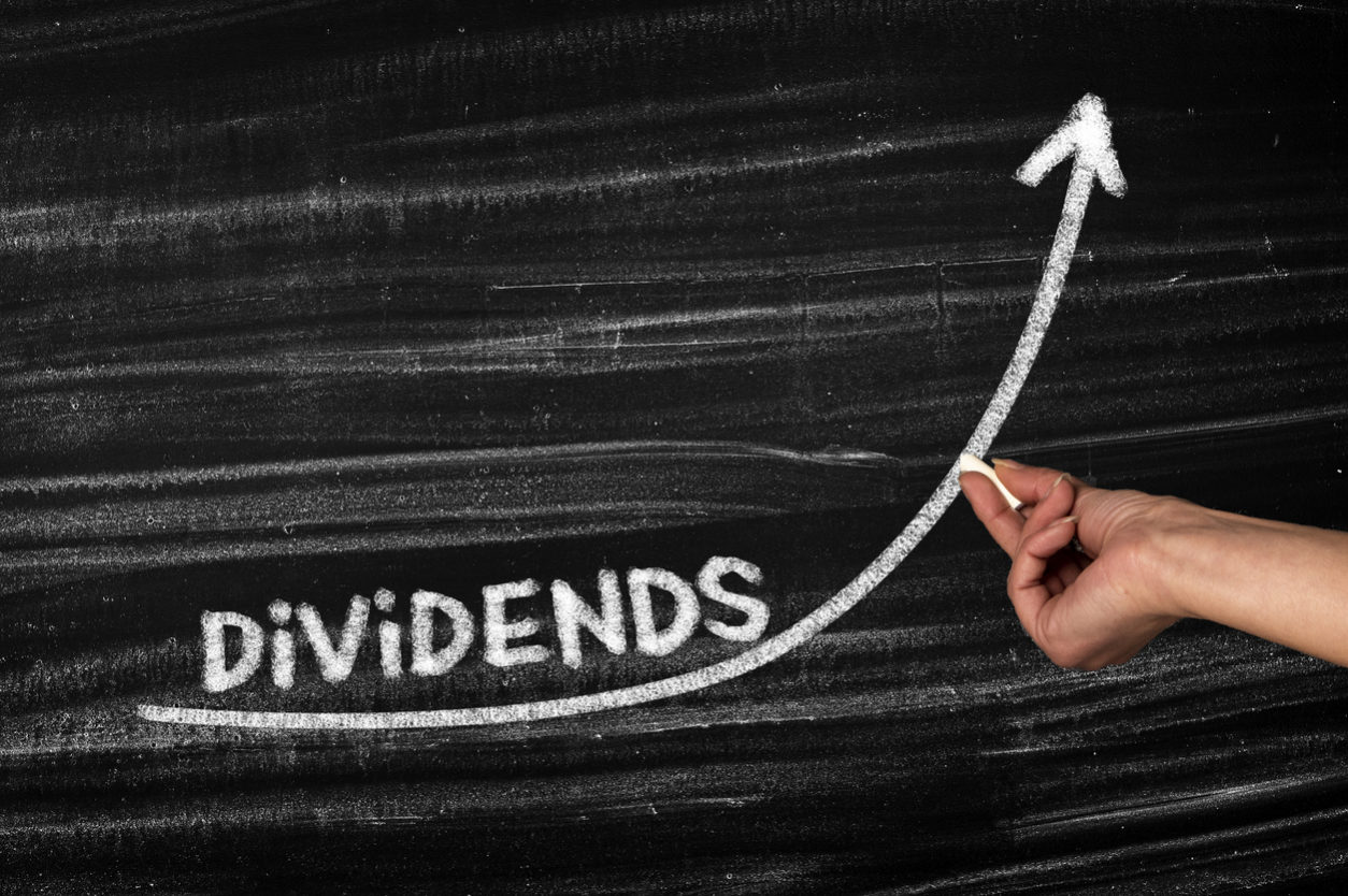 dividends written over an arrow going up on a blackboard with chalk - The Global Dividend Recovery