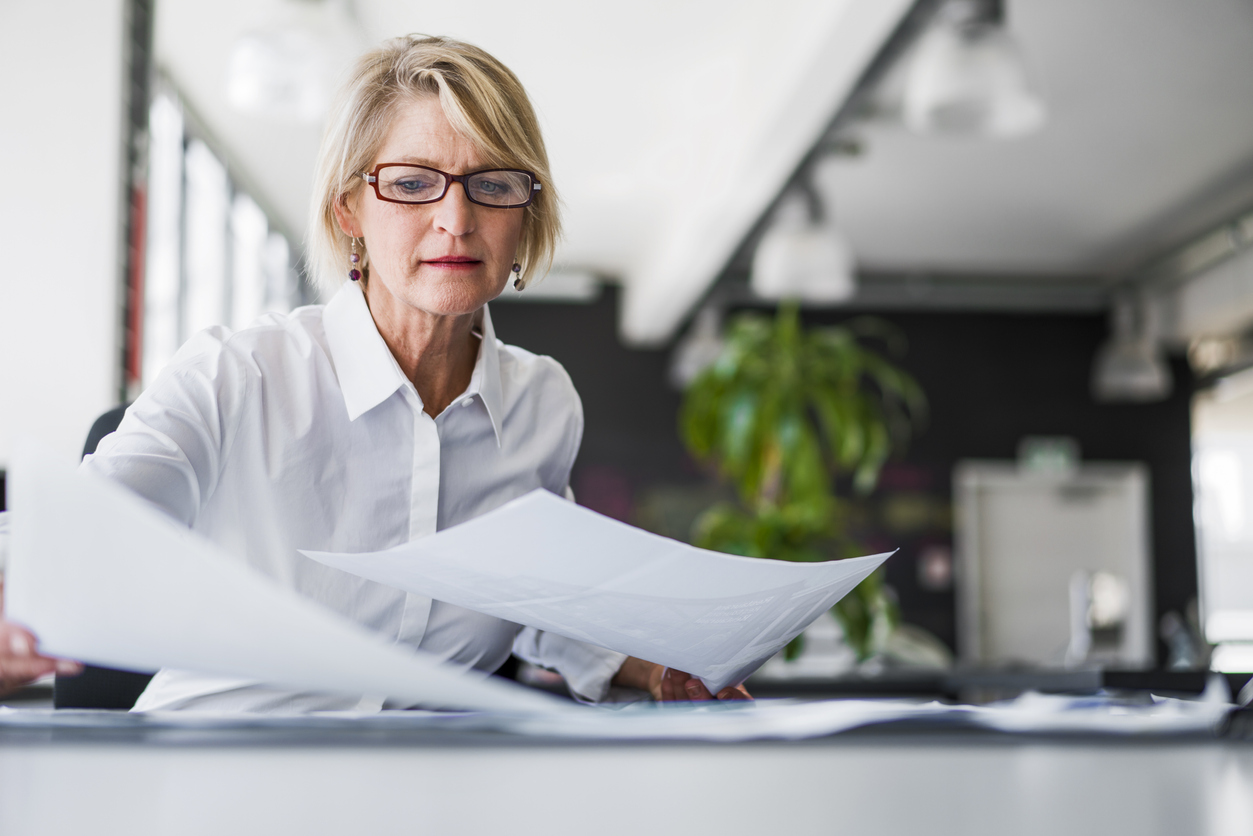 Mature woman reviewing business finances - business planning benefits