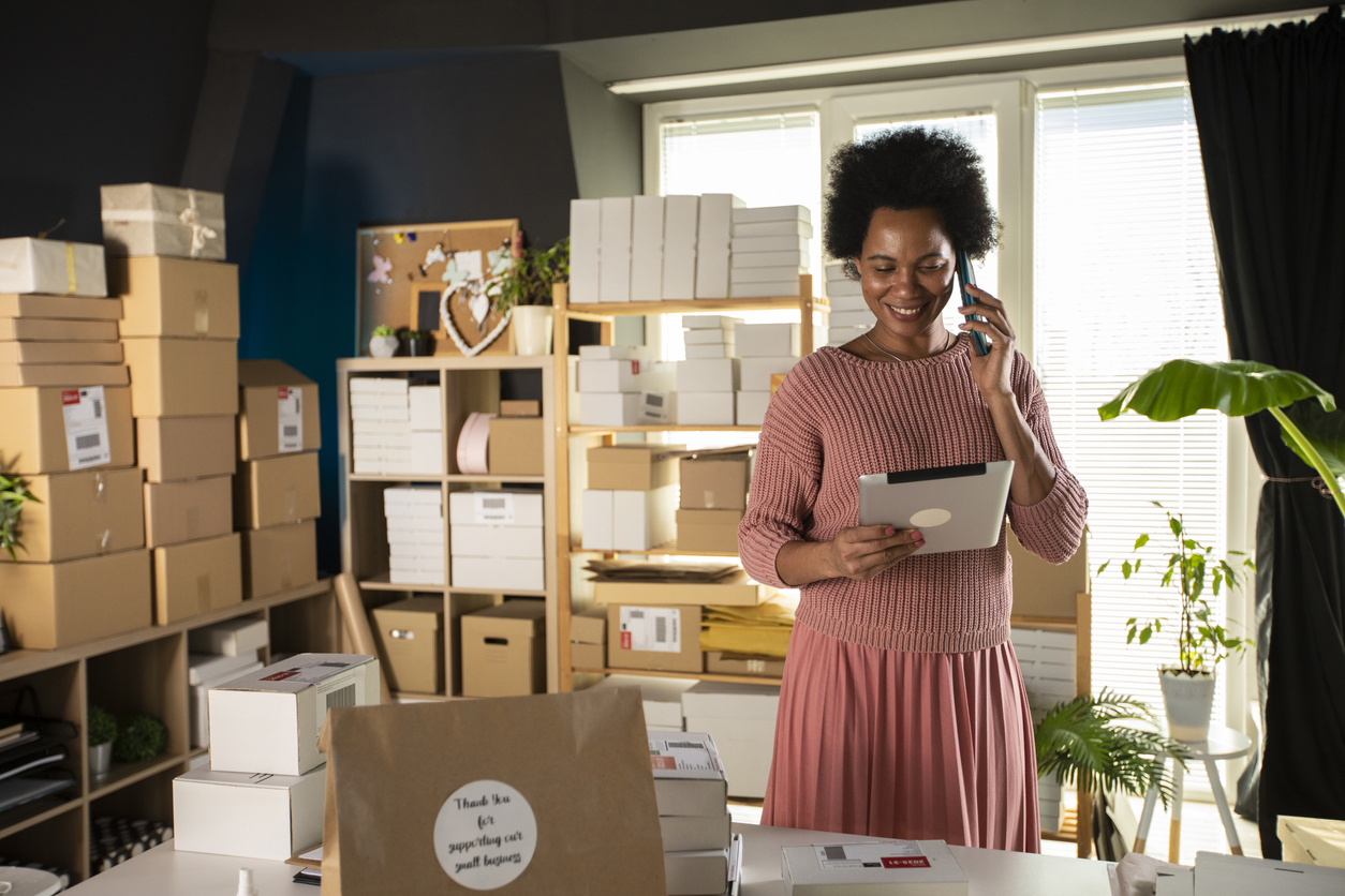 Woman on phone organising delivery of her company products - Do you have earnings beyond your main job?