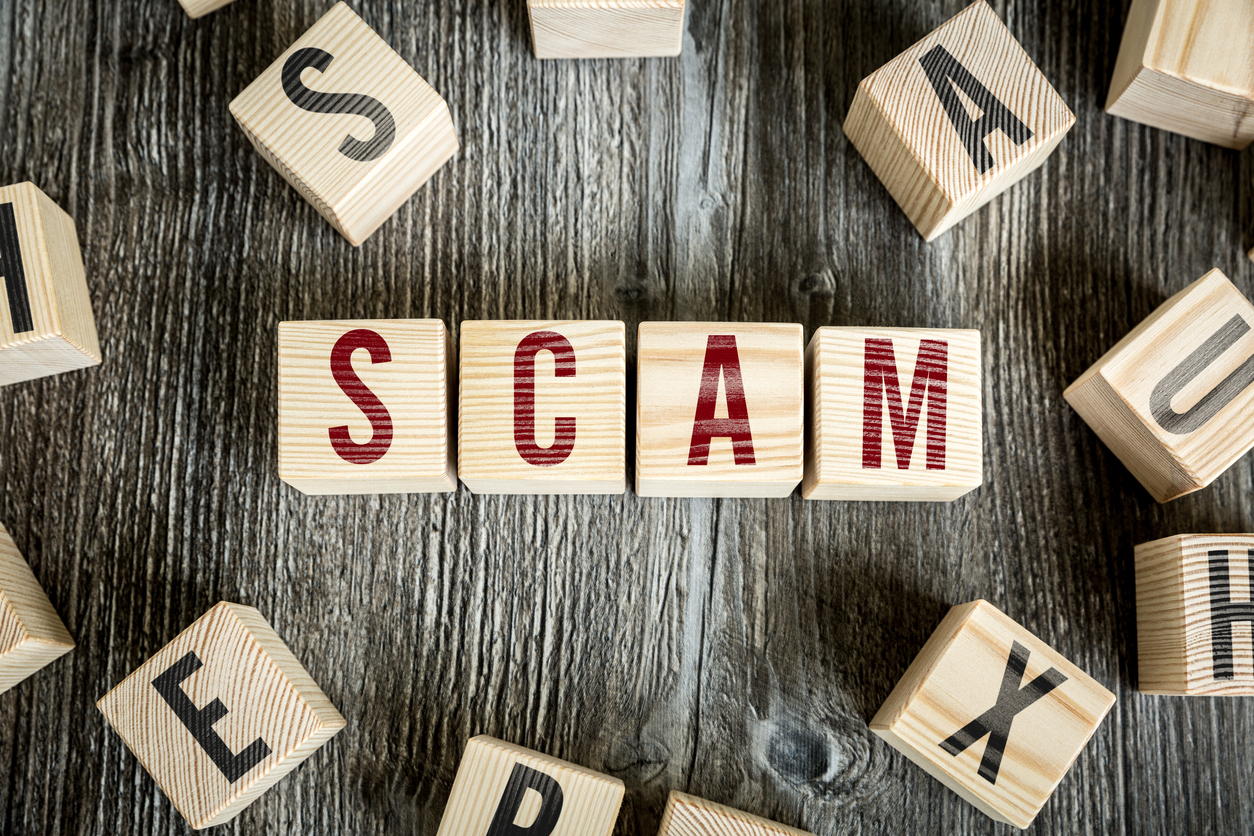 Individual wooden blocks spelling out the word SCAM - Don’t fall victim to a scam
