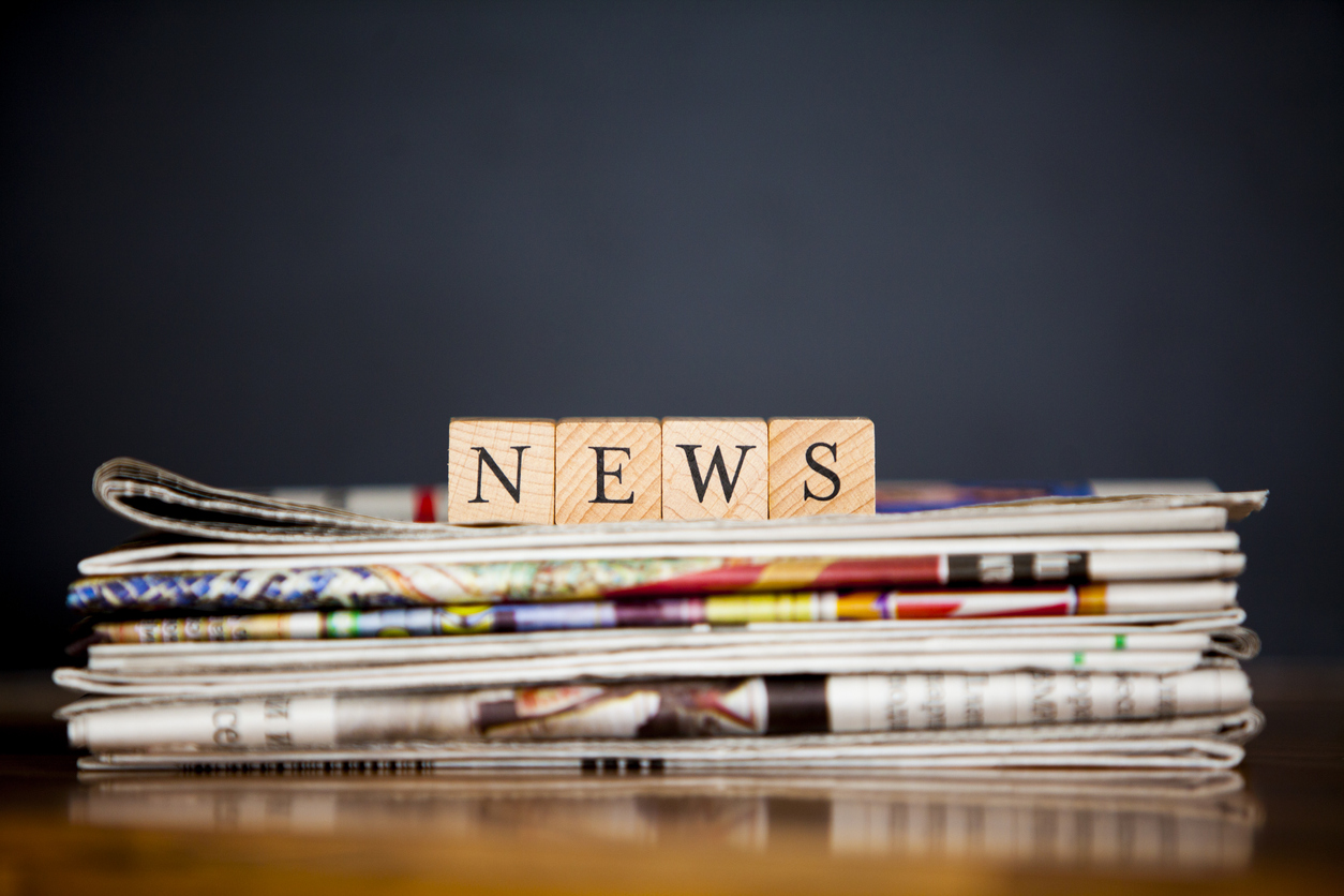Wooden blocks reading News resting on top of a pile of newspapers - news round up january 2023
