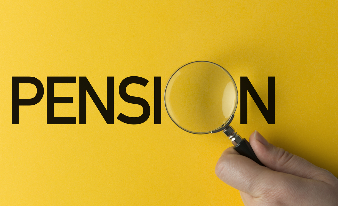 Hand holding magnifying glass on yellow background over the word Pension