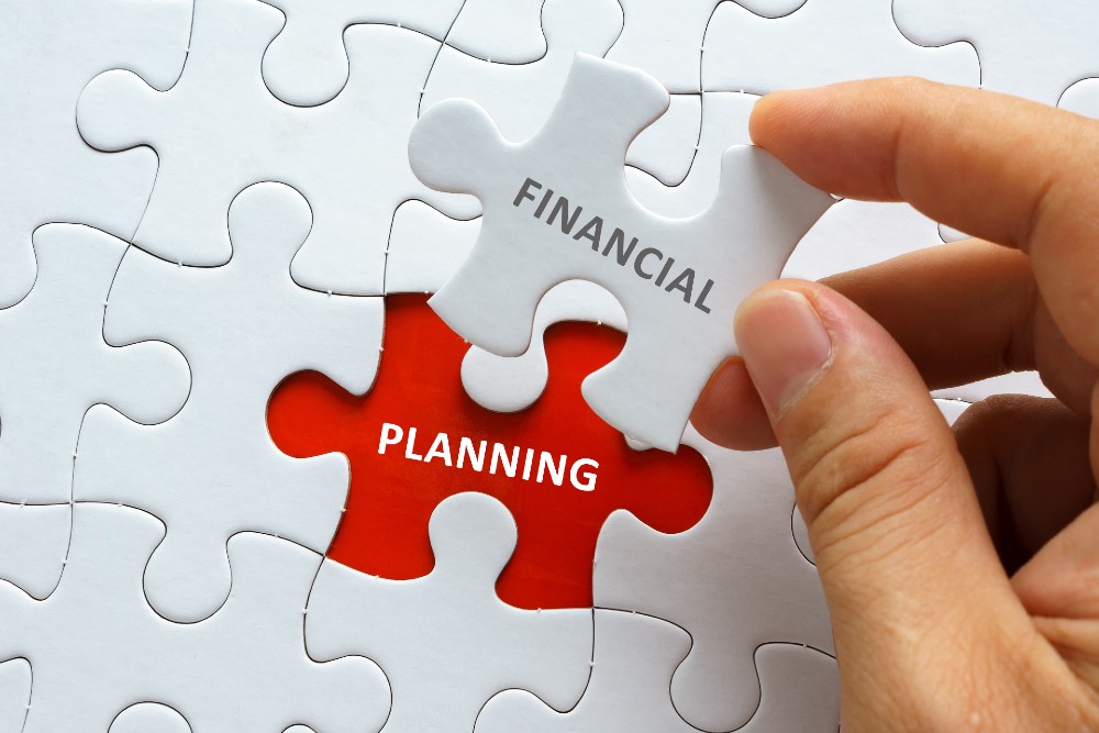 Jigsaw puzzle with pieces labelled 'Financial' and 'Planning' - new tax year 2023
