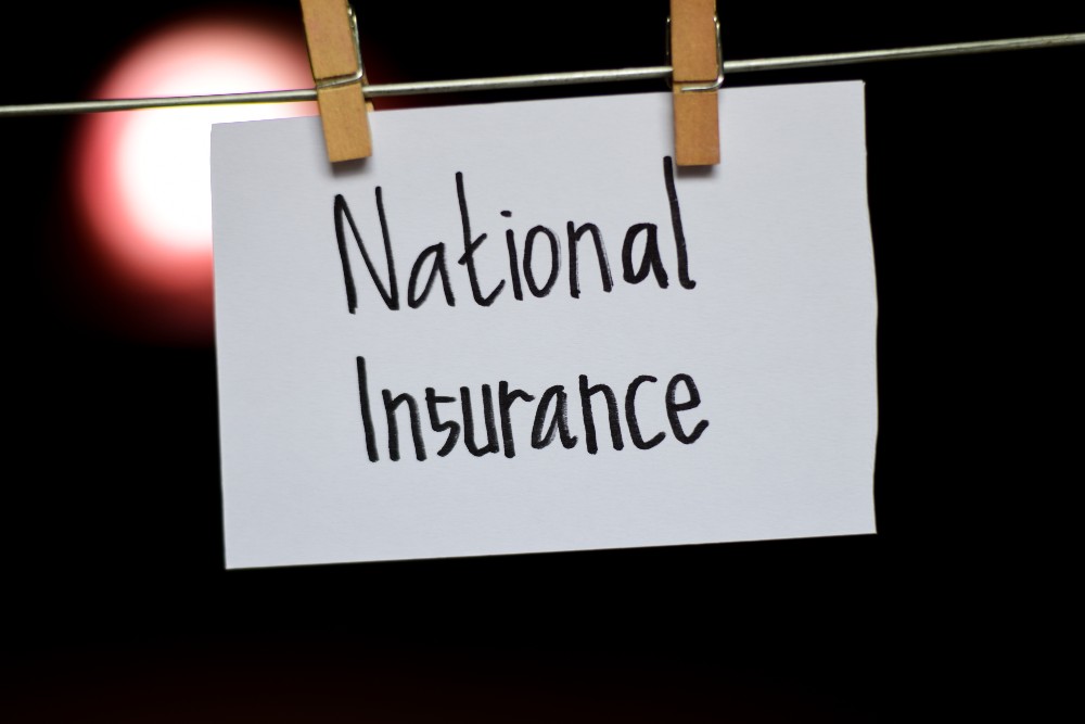 Piece of paper pegged to a line with 'National Insurance' written on it