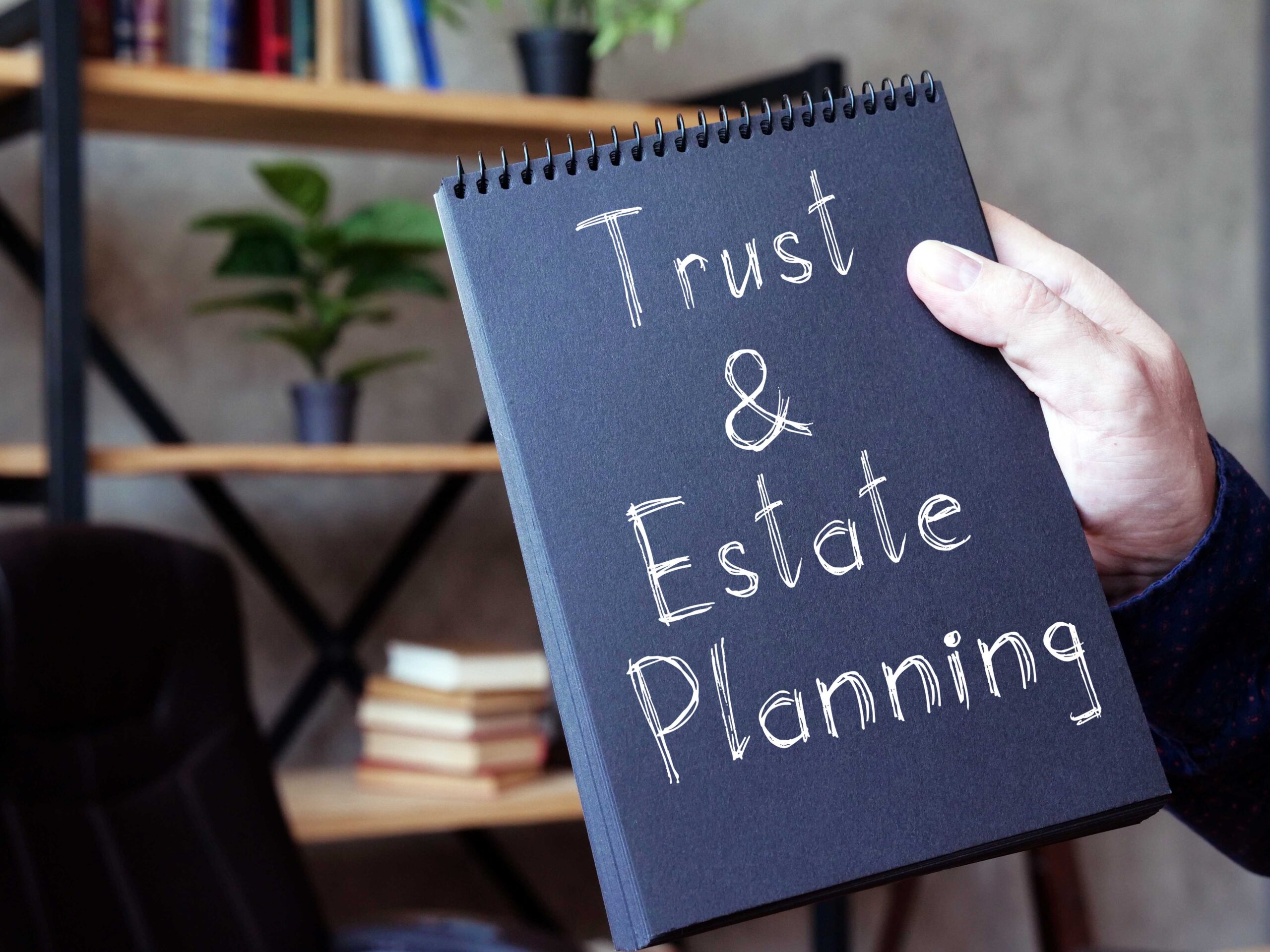 hand holding 'Trust & Estate Planning' book - FCA's unusual warning on trusts